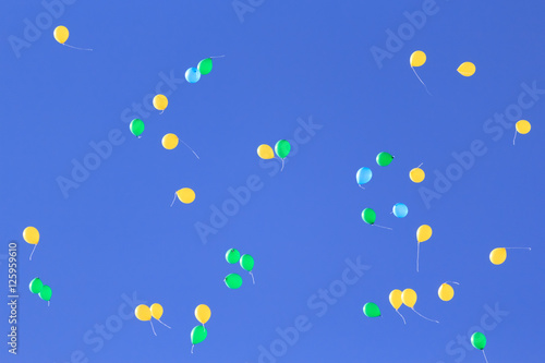 Balloons flying in the sky - no red
