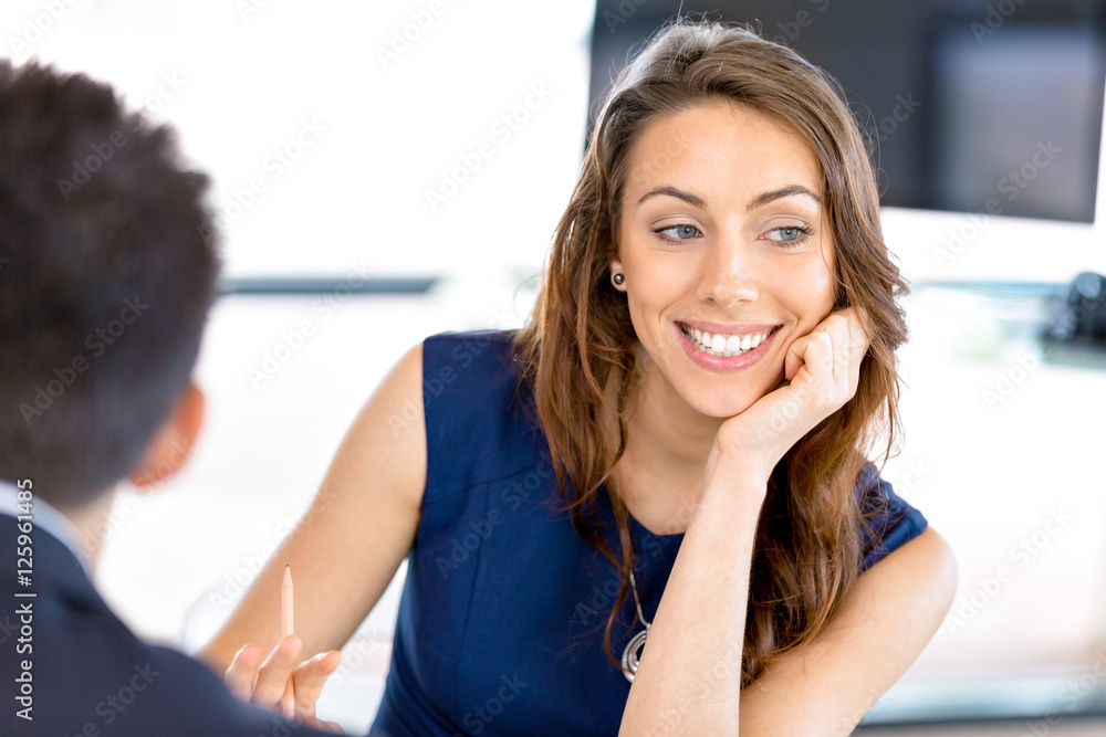 Fototapeta premium Young businesswoman sitting at desk and working