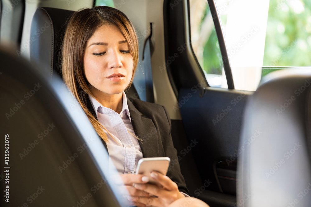 Powerful businesswoman riding a car
