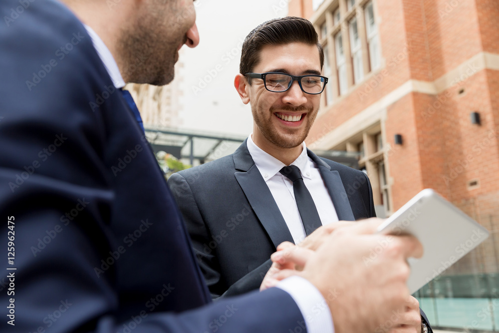 Fototapeta premium Two businessmen talking outdoors