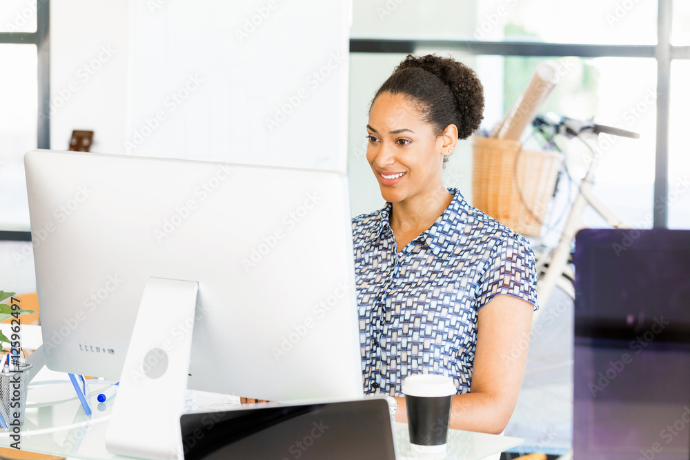 Portrait of smiling afro-american office worker sitting in offfice Portrait of smiling afro-american office worker sitting in offfice