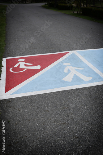 asphalt road in the park and have symbol of people with disabili © meepoohyaphoto