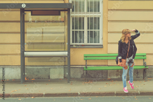 Girl waiting for a bus. photo