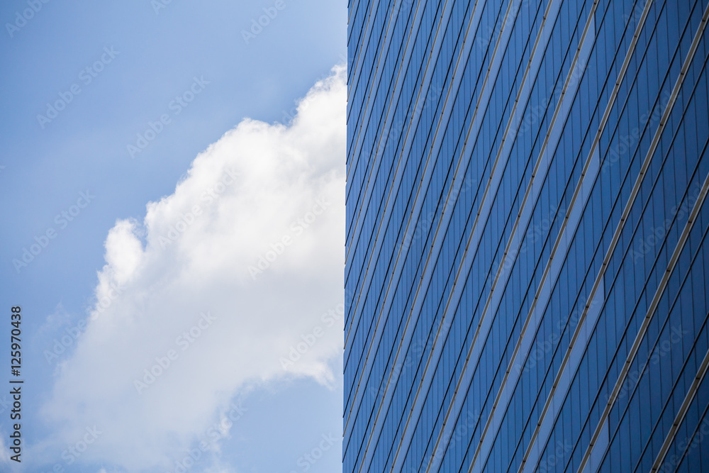 Glass wall in modern office building with blue sky and clouds Glass wall in modern office building with blue sky and clouds