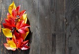 decoration made of red and yellow leaves on rustic wooden table