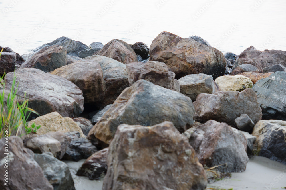 the stones on the beach under the incoming wave the stones on the beach under the incoming wave