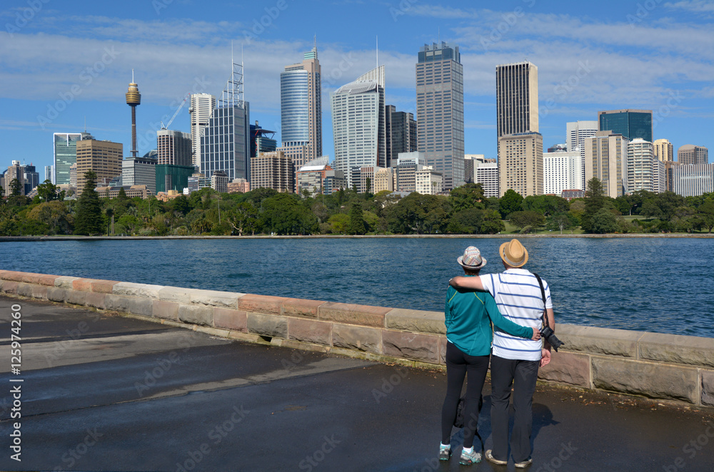 Naklejka premium Senior Couple looks at Sydney Central Business District skylin S
