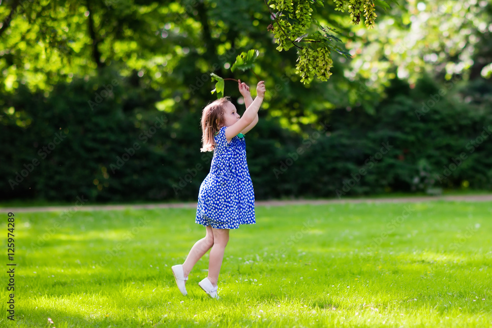 Little girl running in sunny park