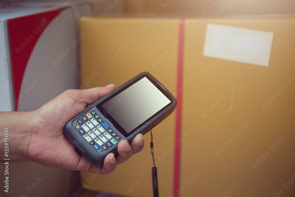 Worker using tablet to scan and check pacel and packet. Worker using tablet to scan and check pacel and packet.
