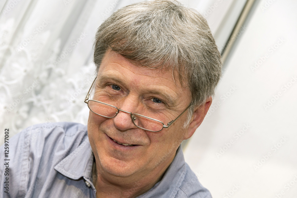 smiling mature man with reading glasses smiling mature man with reading glasses