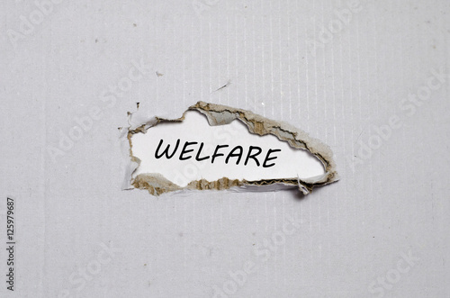 The word welfare appearing behind torn paper photo