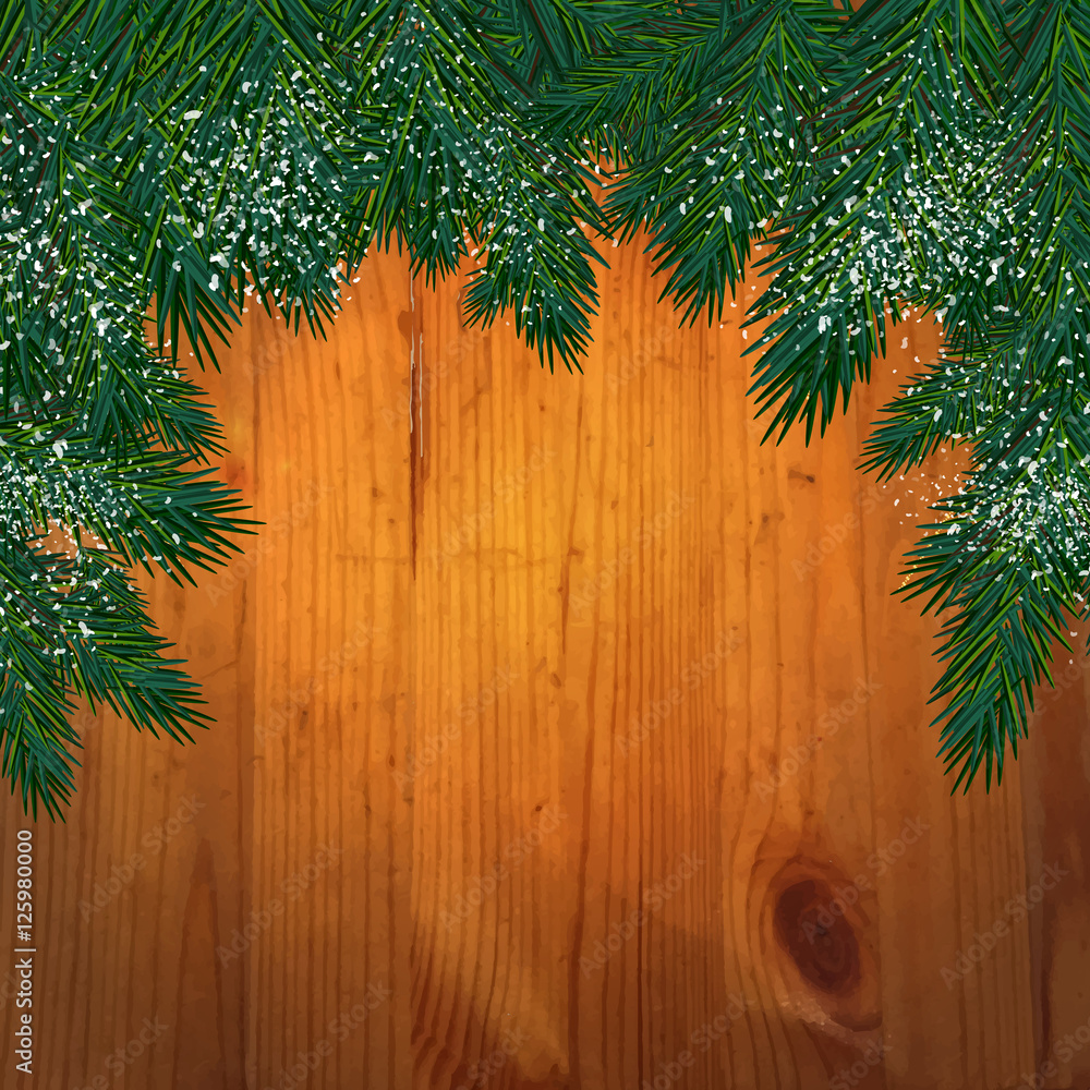 Background with christmas tree branches in front of a wooden wa Background with christmas tree branches in front of a wooden wa