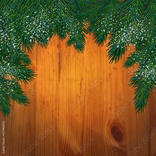 Background with christmas tree branches  in front of a wooden wa © arabel0305