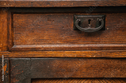 background, texture of ancient wooden furniture close up. vintage drawer closeup, retro sideboard