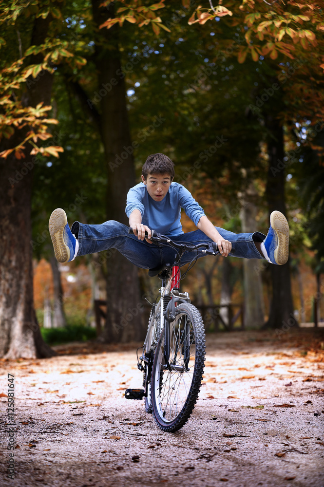 Fototapeta premium Teenager cycling in a park