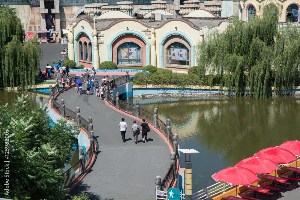 Fototapeta premium People walking on twisty bridge in the amusement park.