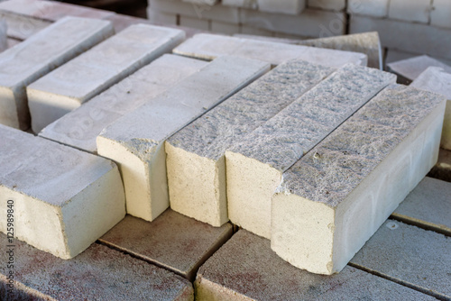 Stack of small rectangular concrete pavers.