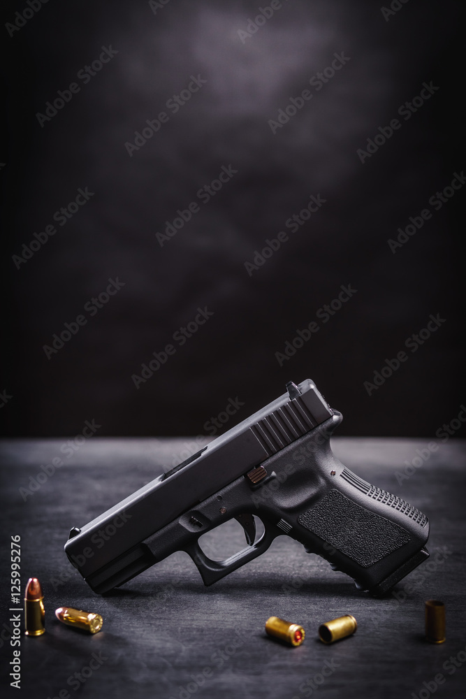 black 9mm pistol on a black wooden table