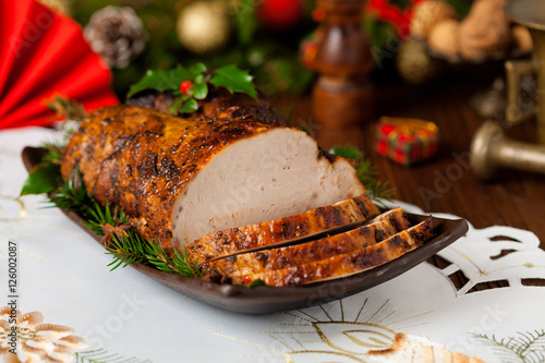 Fotografie Roast pork loin with Christmas decoration.