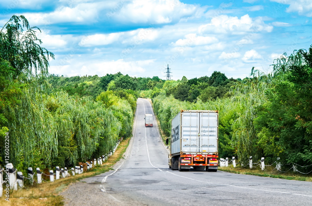trucks driving on summer road