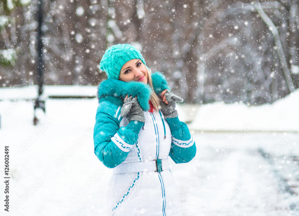 Young happy woman enjoy snow in winter city park outdoor Young happy woman enjoy snow in winter city park outdoor