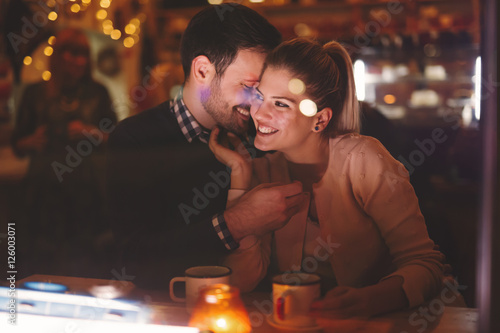 Couple dating at night in pub