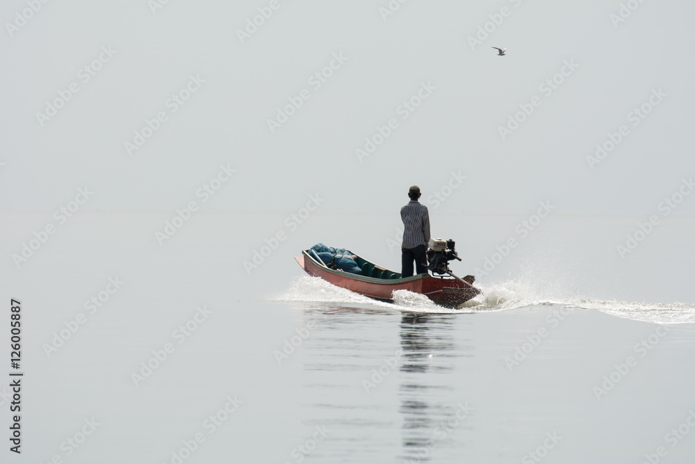 Fototapeta premium NOV 5,2016 : The fisherman sailing at Bangpakong river in Chachengsao Provice east of Thailand.(on white background)