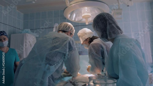Surgical team in process of surgery of reimplantation