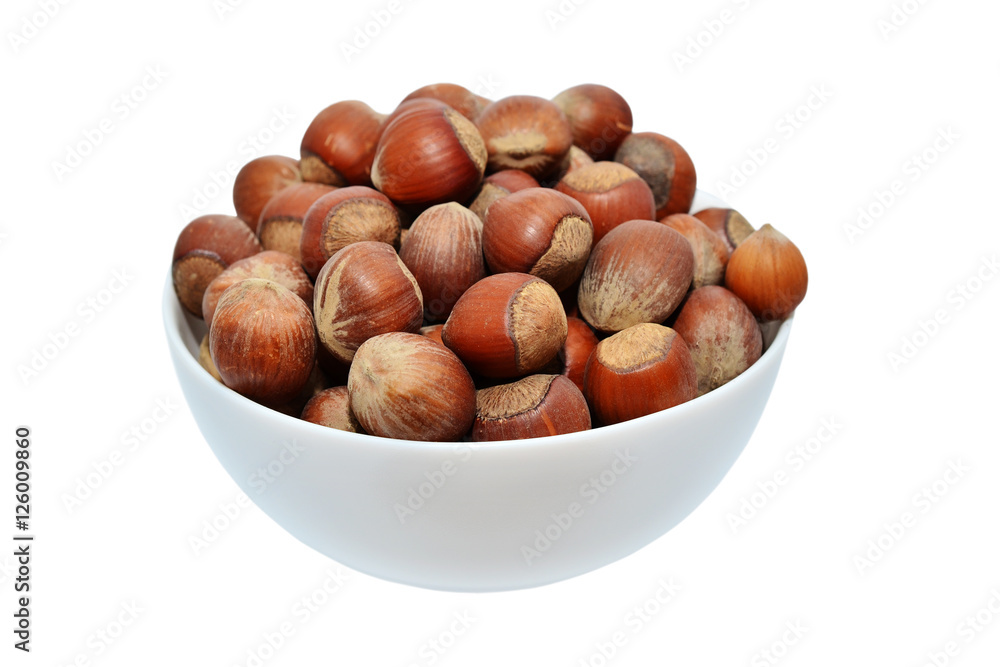 Hazelnut in a wooden bowl isolated on white background Hazelnut in a wooden bowl isolated on white background