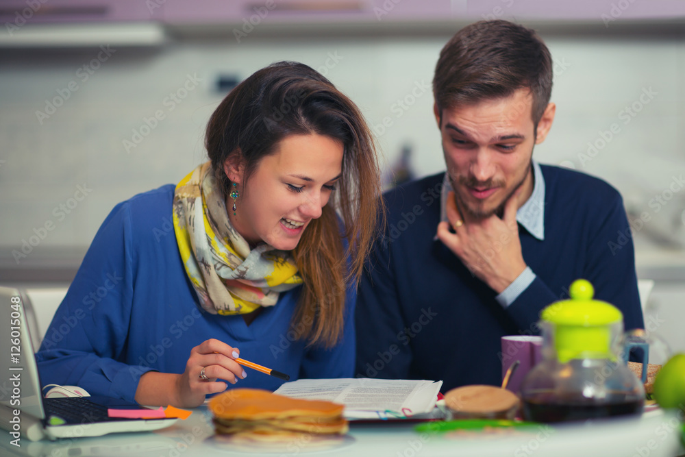 Cute couple doing documentation for home budgeting at home Cute couple doing documentation for home budgeting at home