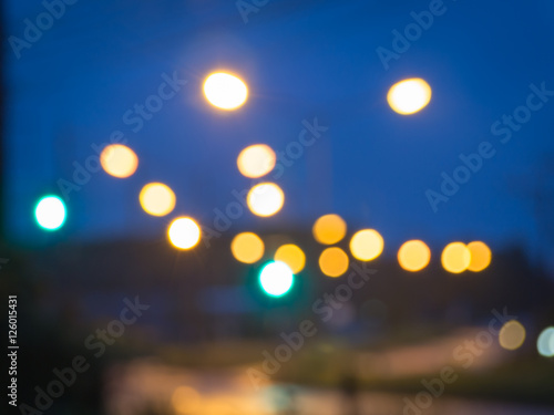 Lights blurred bokeh background from road side at night time. © daddyohm