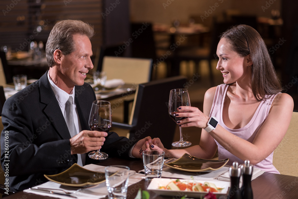 Delighted couple drinking wine in the restaurant