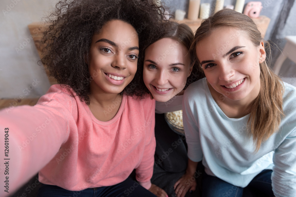 Young smiling friends taking selfie in the bedroom at home Young smiling friends taking selfie in the bedroom at home