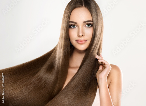 Beautiful blonde woman with long, healthy , straight and shiny hair. Hairstyle loose hair 