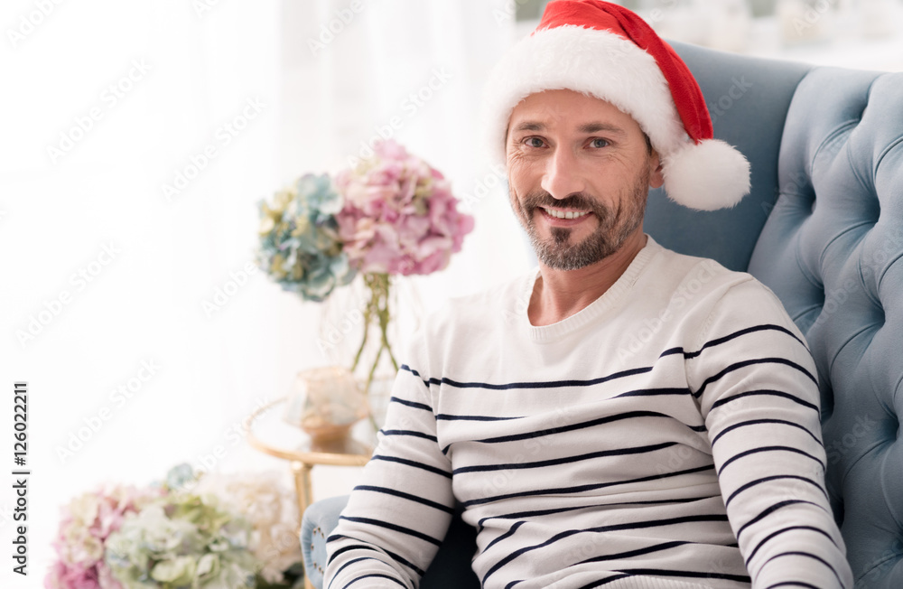 Handsome cheerful man wearing a Santa hat Handsome cheerful man wearing a Santa hat