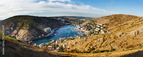 Panorama view of Balaclava from the ancient fortress Chembalo. Balaclava Bay with yachts in bright sunny day. Crimea, Rusiia. photo
