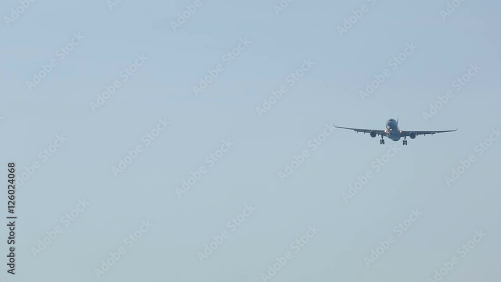 Widebody airplane approaching over ocean Widebody airplane approaching over ocean