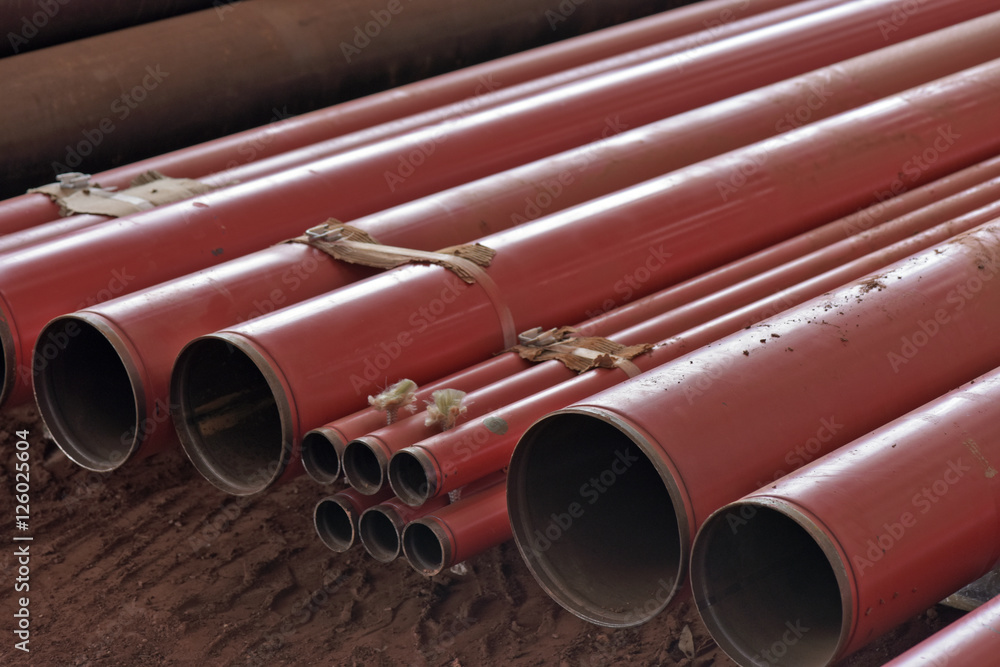 Fototapeta premium Pile of red conduit to install on building