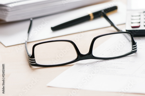 Pen and glasses on documents