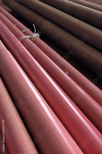 Pile of red conduit to install on building