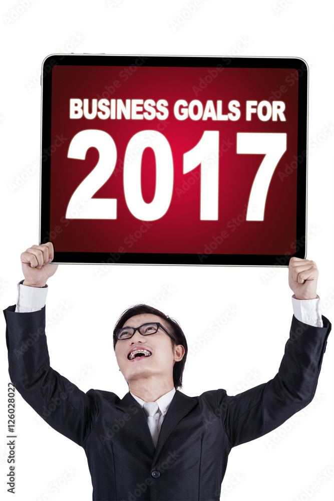 Businessman holding text and numbers on a board Businessman holding text and numbers on a board