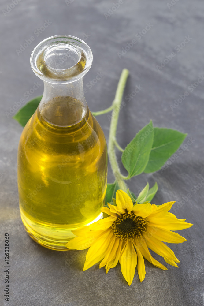 Jug sunflower oil with flower isolated Jug sunflower oil with flower isolated