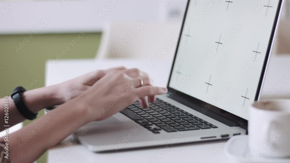 Crop close up female hands working and typing at laptop sitting at desktop on blurred background. Crop close up female hands working and typing at laptop sitting at desktop on blurred background.
