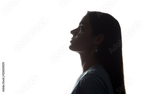Young woman looking up with flowing hair - horizontal silhouette