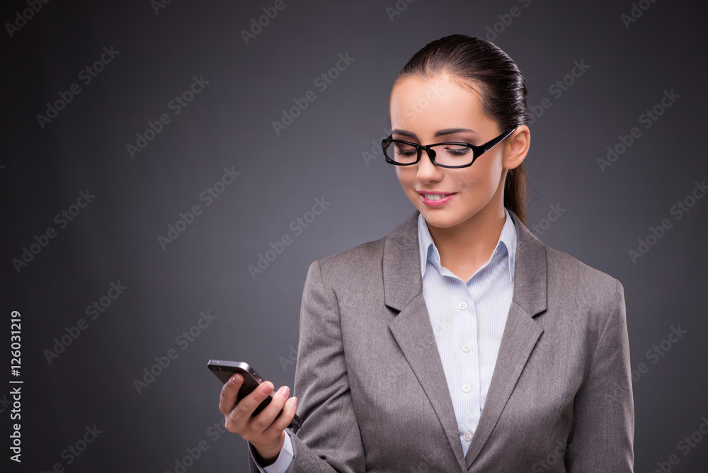 Businesswoman using mobile phone in business concept Businesswoman using mobile phone in business concept