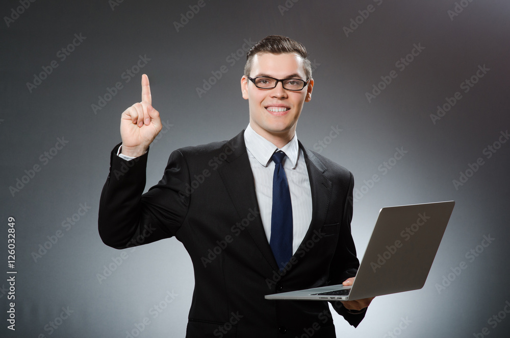 Young businessman with laptop in business concept Young businessman with laptop in business concept