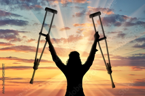 Happy disabled person with raised hands crutches Fototapeta