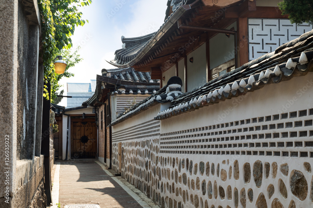 Small and empty alley and old buildings at the Bukchon Hanok Village in Seoul, South Korea. Small and empty alley and old buildings at the Bukchon Hanok Village in Seoul, South Korea.