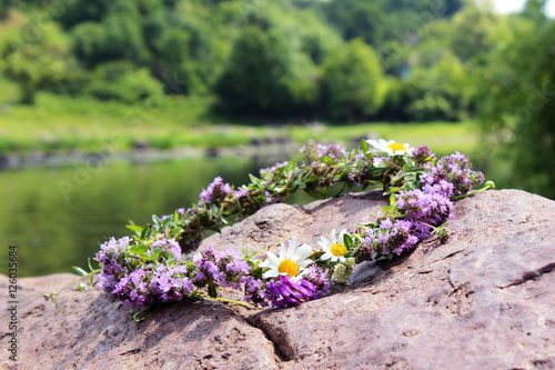 A wreath of wild flowers lying on the stone
