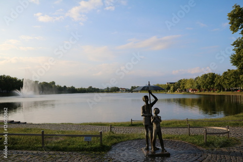 Pond Pfaffenteich in Schwerin, Umbrella children at shore, Mecklenburg Germany